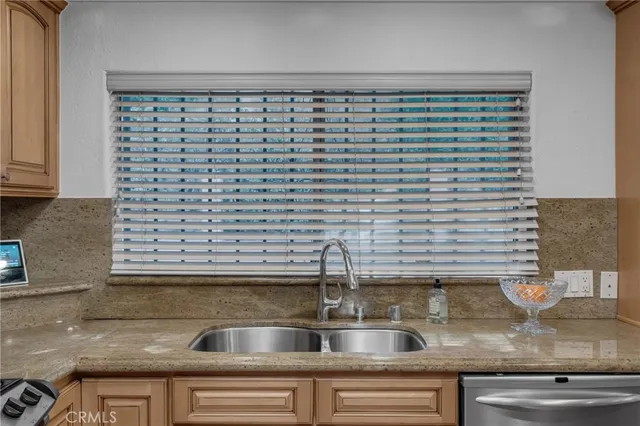 a kitchen with a sink and a wooden floor