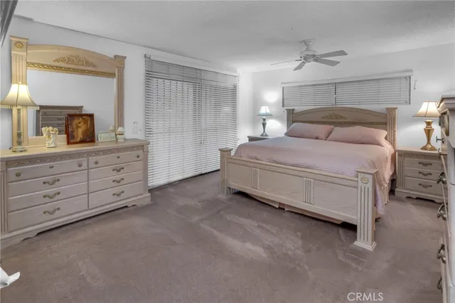 a spacious bedroom with a bed and a dresser