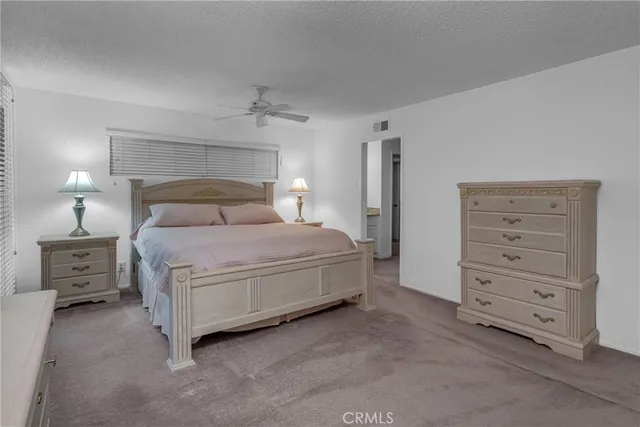 a bedroom with a bed and a night stand
