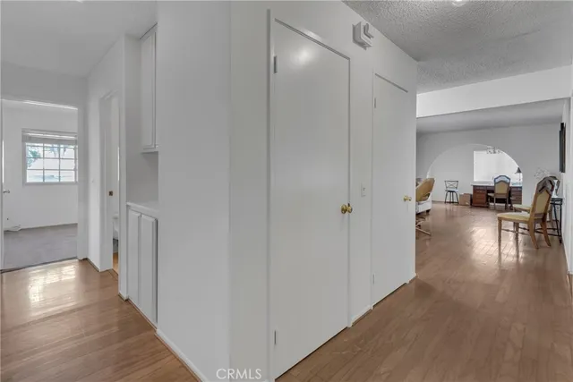a view of a hallway view with wooden floor and furniture