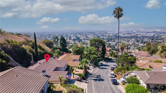 an aerial view of a house with a yard