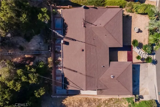 an aerial view of a house with a yard