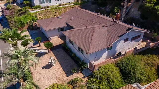 an aerial view of a house with table and chairs