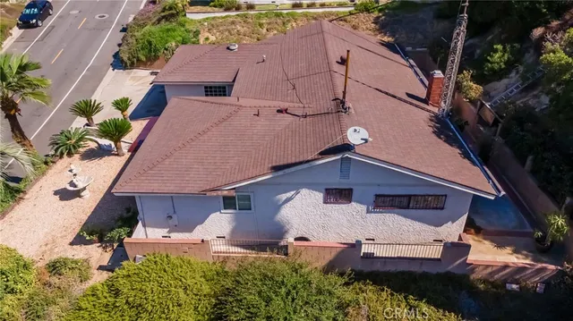 an aerial view of multiple houses with a mountain