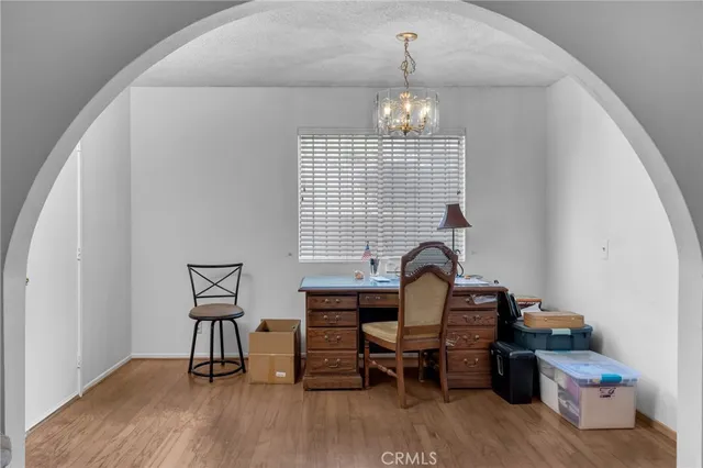 a view of a workspace with furniture and a window