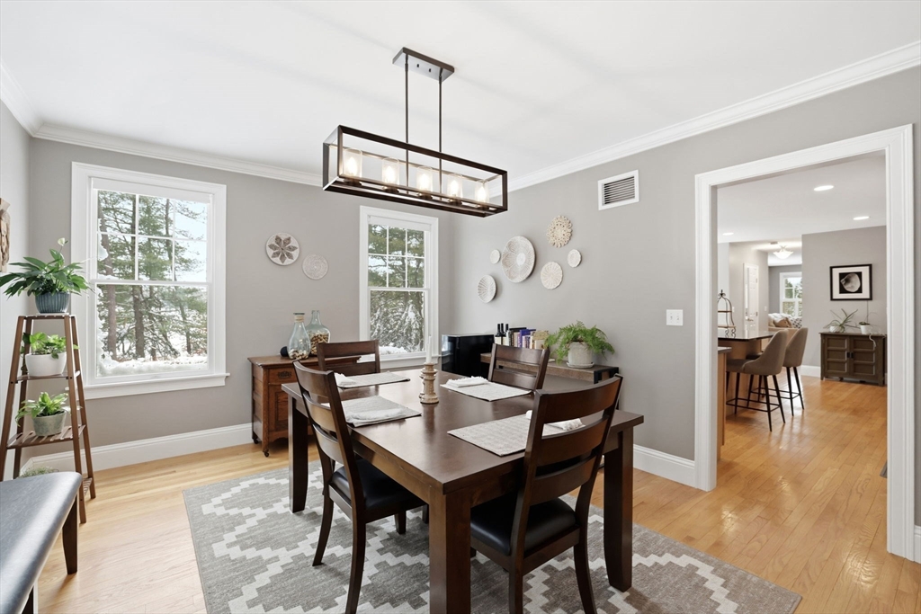 18 Red Pine Lane Wareham, MA 02571 - Photo 12 of 37 a view of a dining room and livingroom with furniture wooden floor a chandelier