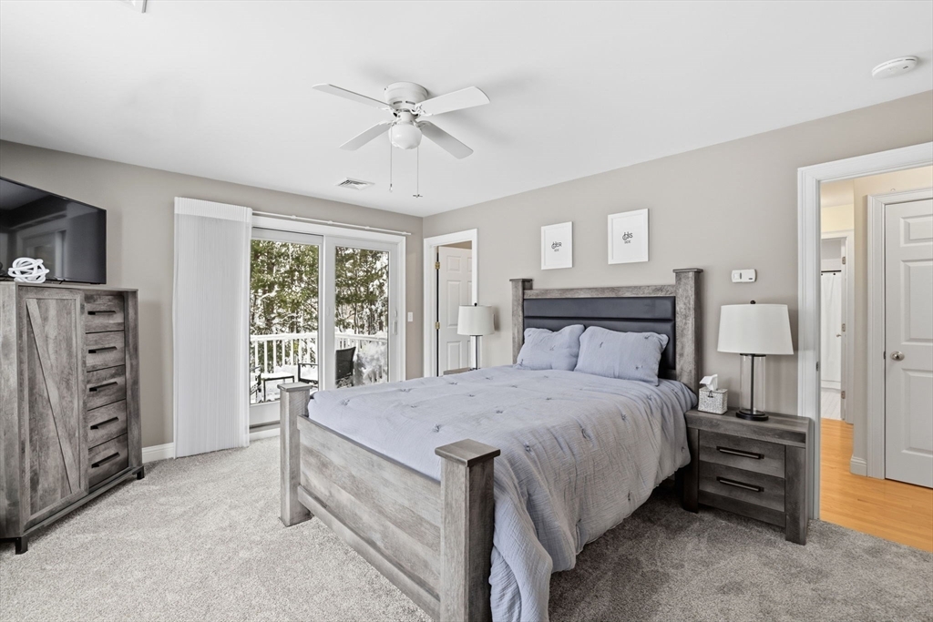 18 Red Pine Lane Wareham, MA 02571 - Photo 15 of 37 a bedroom with a bed and a chandelier
