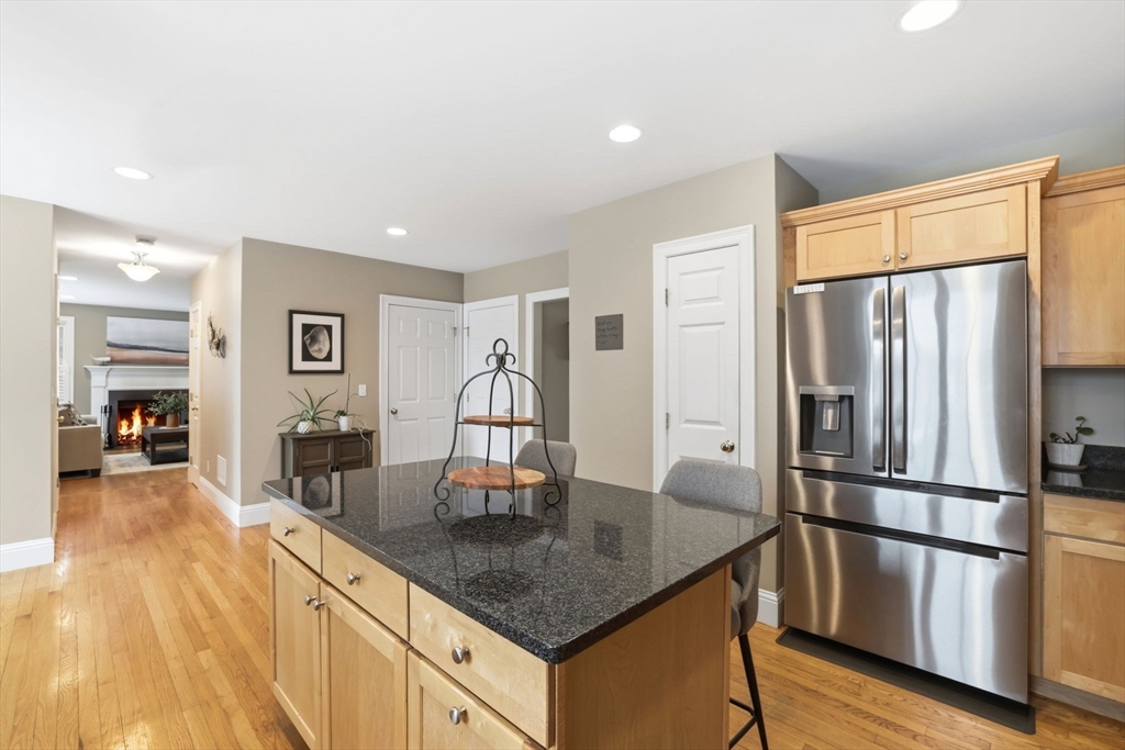 18 Red Pine Lane Wareham, MA 02571 - Photo 7 of 37 a kitchen with stainless steel appliances granite countertop a refrigerator a stove and a kitchen island with wooden floor