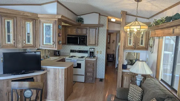 a kitchen with a refrigerator and a stove top oven