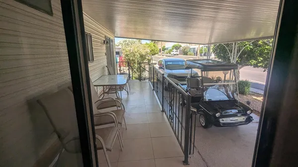 a balcony view with a large window and sitting space