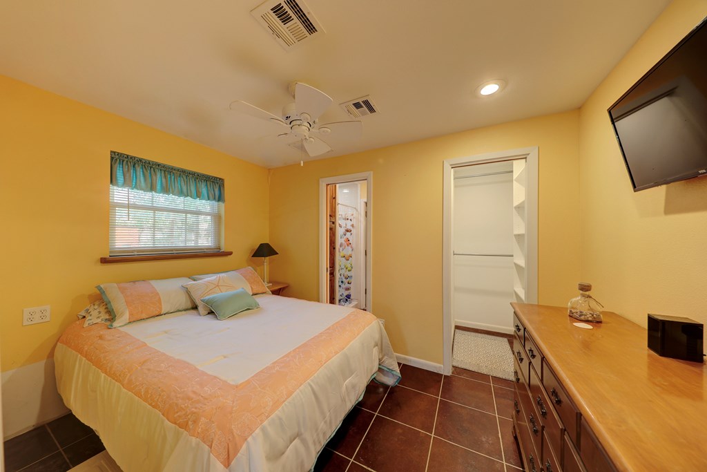 206 Austin Street Ingram, TX 78025 - Photo 11 of 18 a bedroom with a bed and a flat screen tv