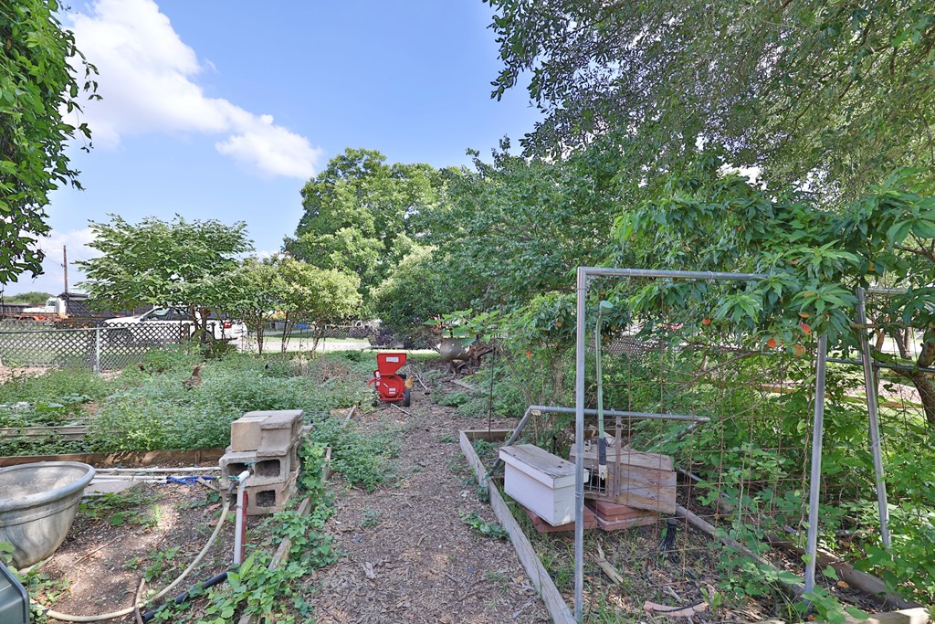 206 Austin Street Ingram, TX 78025 - Photo 18 of 18 a view of a chair and fire pit in backyard of the house