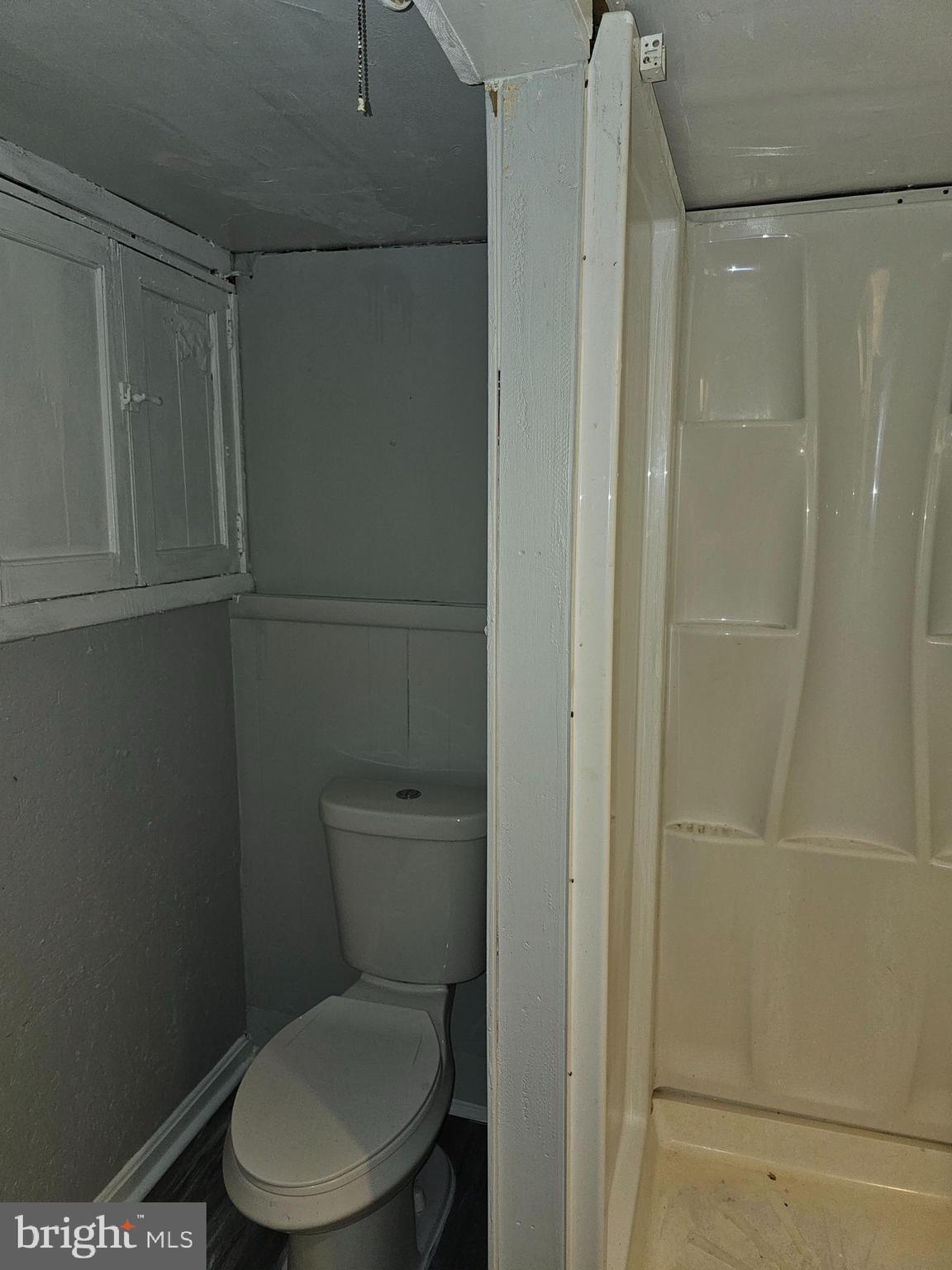 3607 Belair Road, Unit BSMT Baltimore, MD 21213 - Photo 13 of 14 a white toilet sitting next to a shower