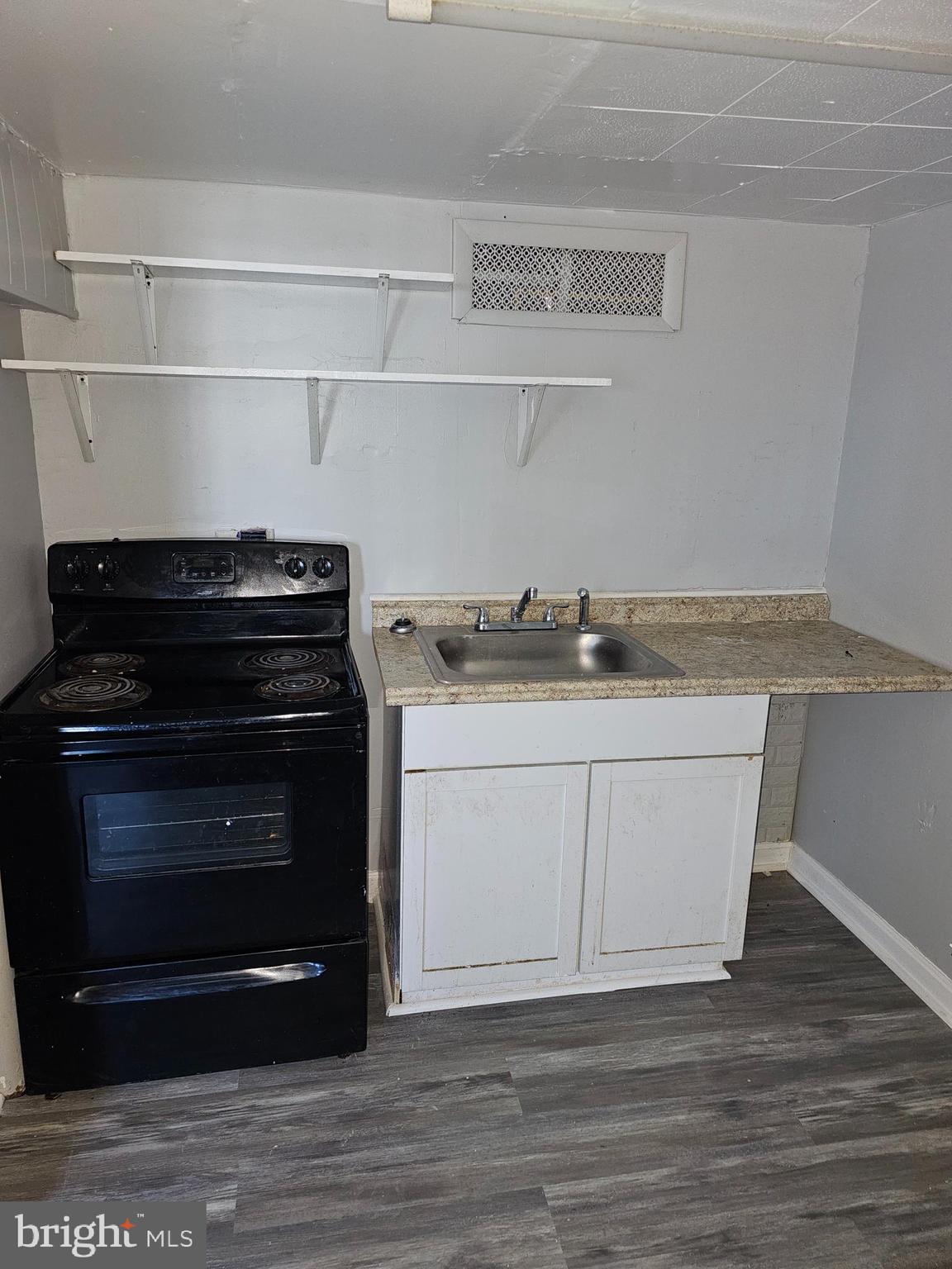 3607 Belair Road, Unit BSMT Baltimore, MD 21213 - Photo 9 of 14 a kitchen with a sink and cabinets