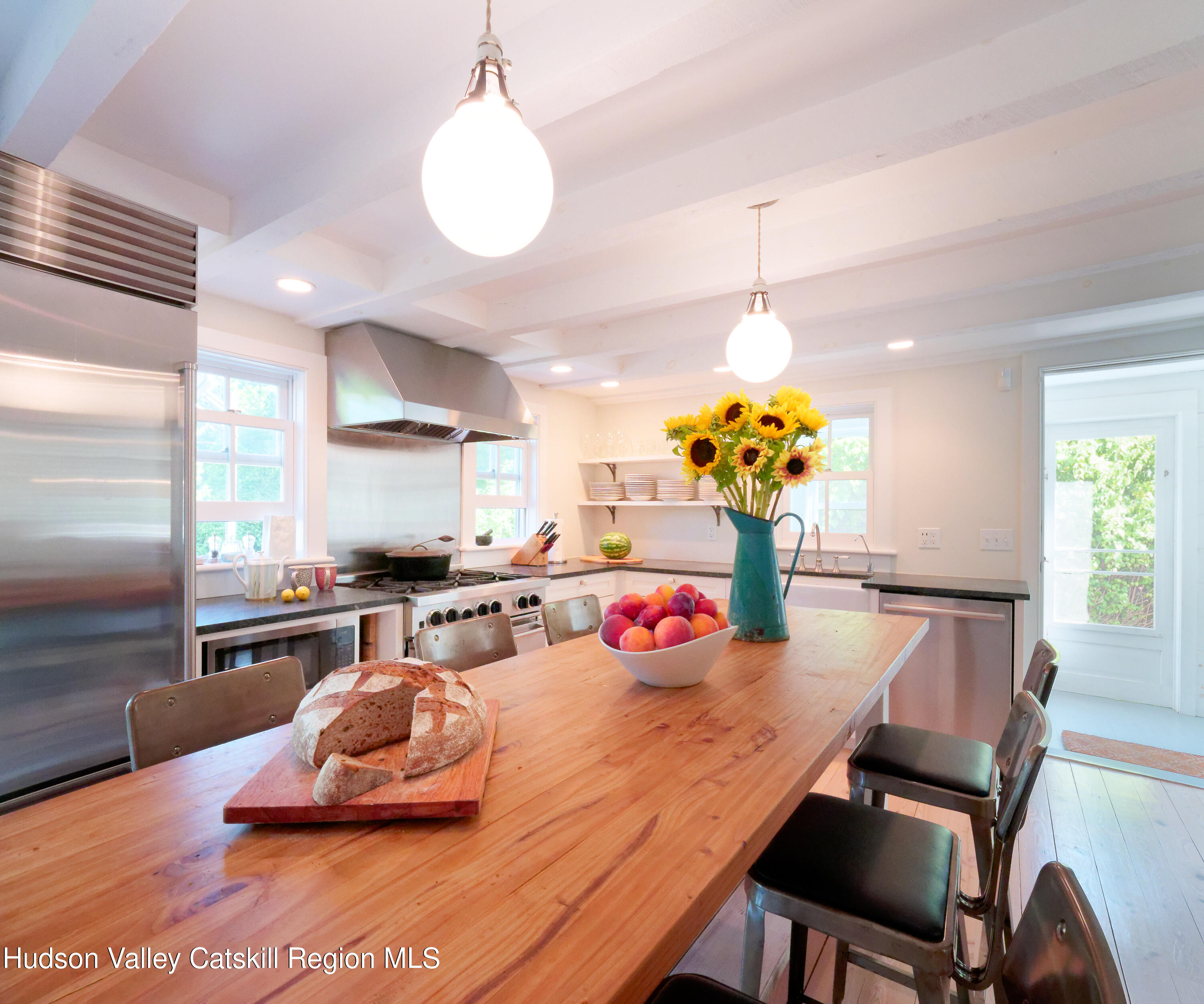 5 Fulton Homestead Road Red Hook, NY 12571 - Photo 14 of 41 a kitchen with stainless steel appliances dining table and chairs