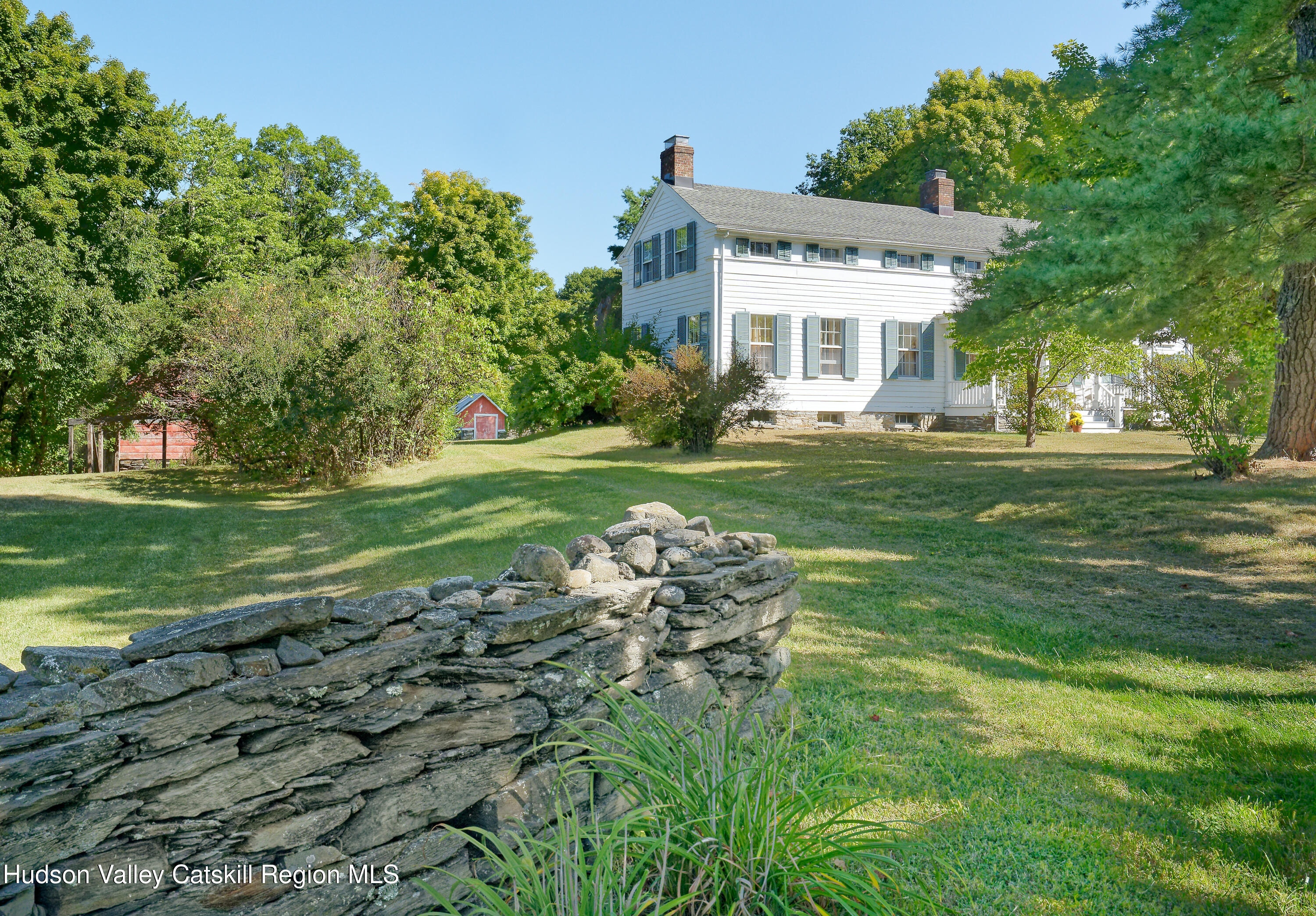 5 Fulton Homestead Road Red Hook, NY 12571 - Photo 5 of 41 a front view of a house with a garden