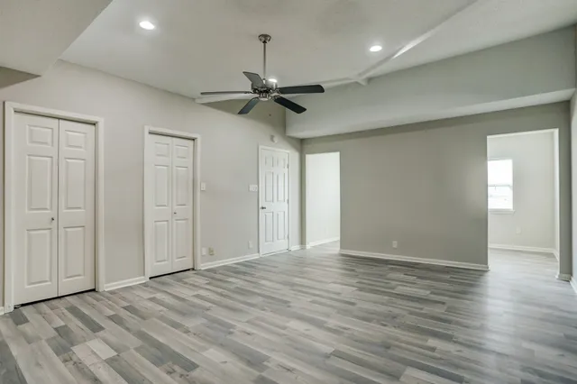 a view of an empty room and wooden floor