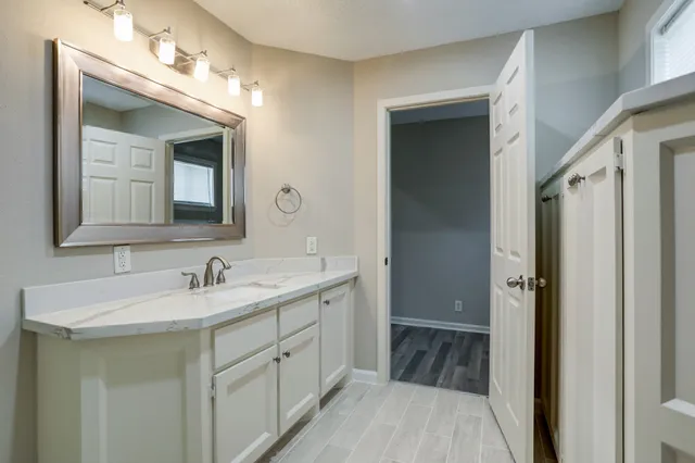 a bathroom with a double vanity sink mirror and