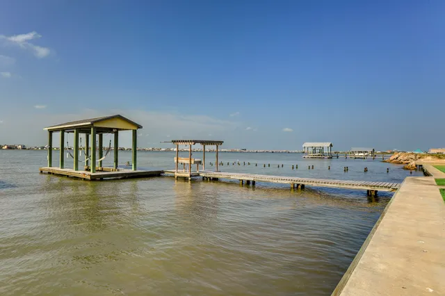 a view of a kitchen with kitchen island a sink wooden floor and floors