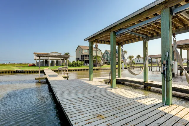 a patio with lawn chairs and wooden floor