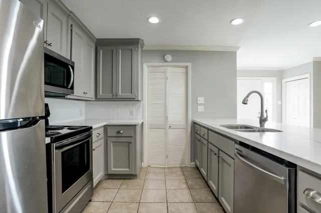 a kitchen with a sink stove and microwave