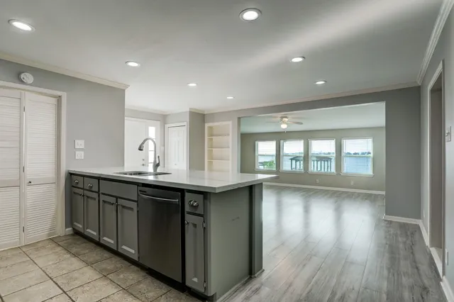 a kitchen with a sink and wooden cabinets