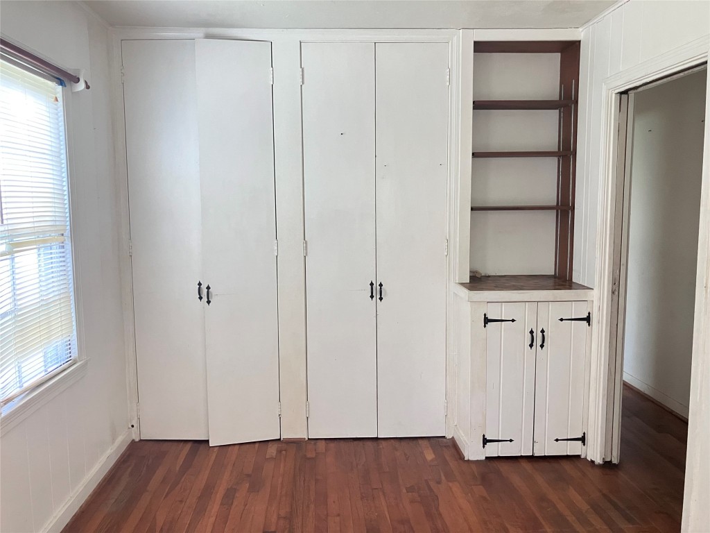 5012 Winding Way Dickinson, TX 77539 - Photo 16 of 23 an empty room with wooden floor closet and windows
