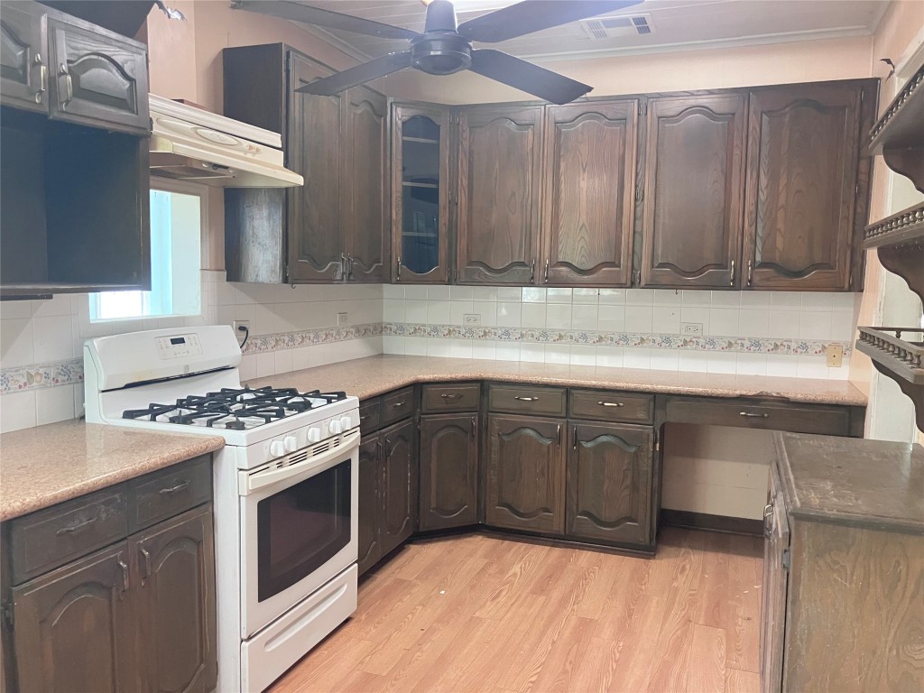 5012 Winding Way Dickinson, TX 77539 - Photo 7 of 23 a kitchen with stainless steel appliances granite countertop a stove a sink and a microwave