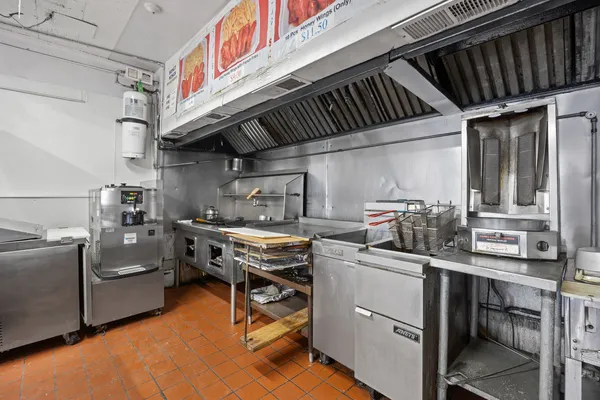a kitchen with cabinets and chairs