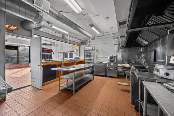 a living room with lots of furniture and a kitchen