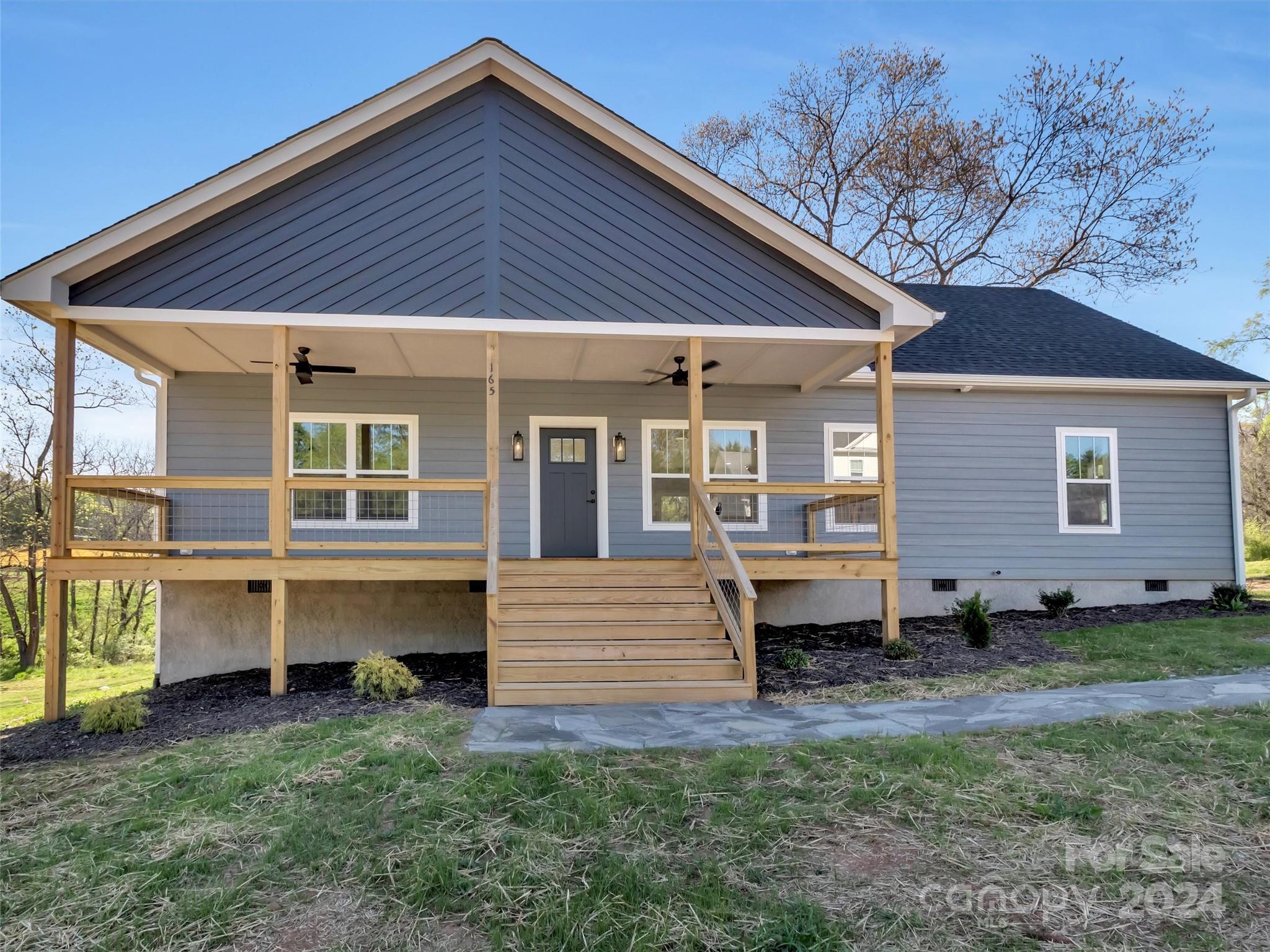 165 Rdg Vw Drive, Unit 19 Clyde, NC 28721 - Photo 3 of 30 a front view of a house with a yard