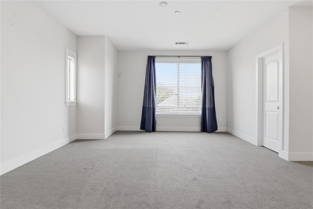 4211 Rawlins Street, Unit 530 Dallas, TX 75219 - Photo 18 of 33 an empty room with windows