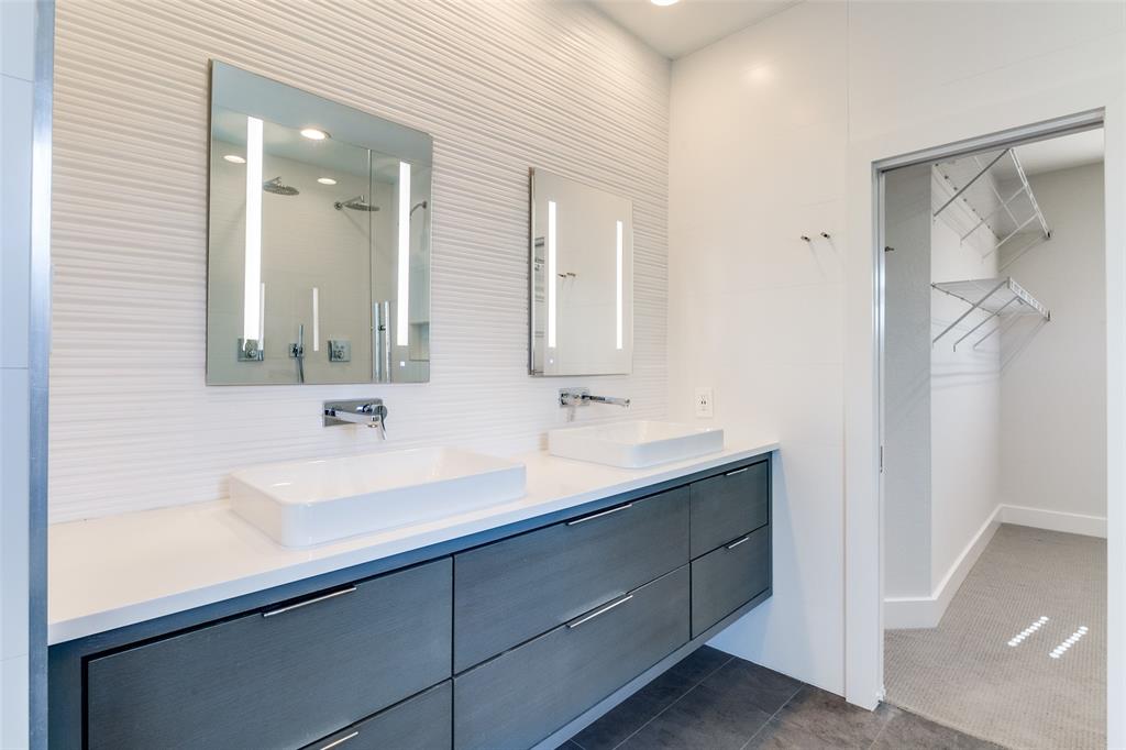 4211 Rawlins Street, Unit 530 Dallas, TX 75219 - Photo 19 of 33 a bathroom with a sink and a mirror
