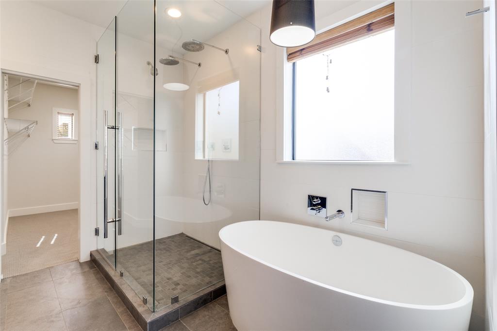 4211 Rawlins Street, Unit 530 Dallas, TX 75219 - Photo 20 of 33 a white bath tub sitting next to a bathroom
