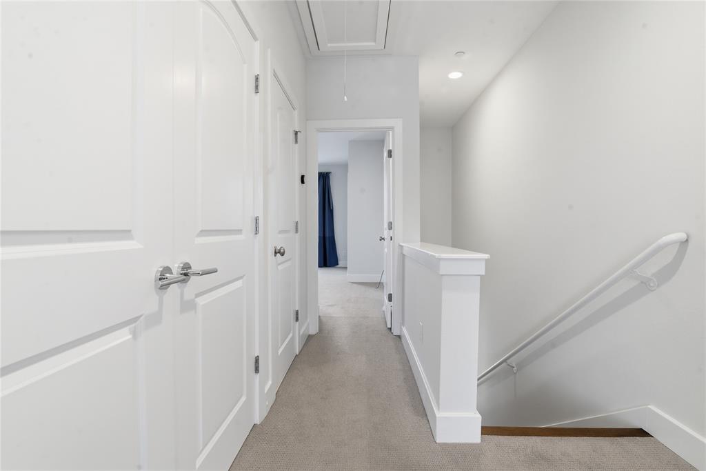 4211 Rawlins Street, Unit 530 Dallas, TX 75219 - Photo 21 of 33 a view of a hallway with white walls