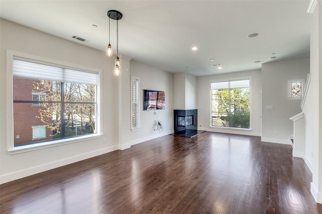 4211 Rawlins Street, Unit 530 Dallas, TX 75219 - Photo 6 of 33 a view of an empty room with wooden floor and a window