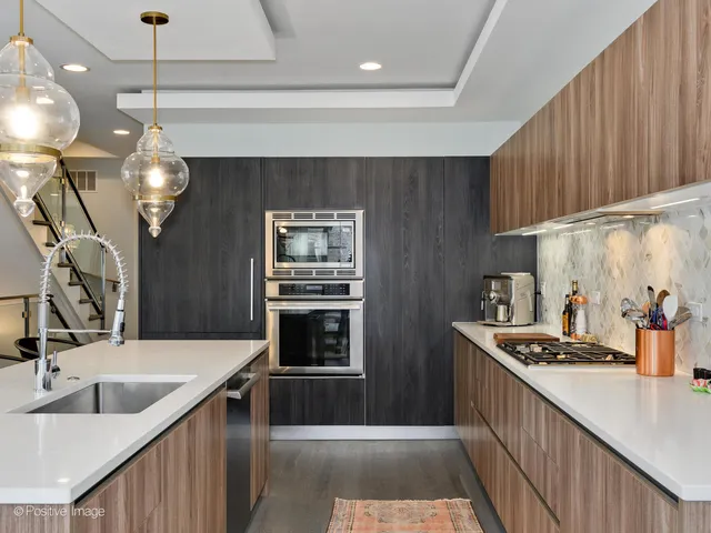 a kitchen with cabinets a sink and appliances