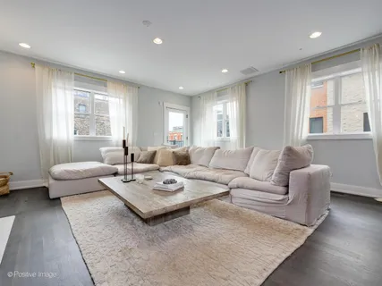 a living room with furniture couches and a large window