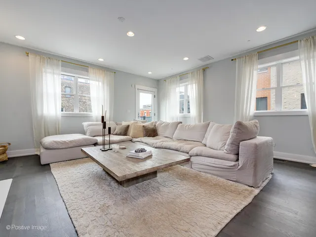 a living room with furniture couches and a large window