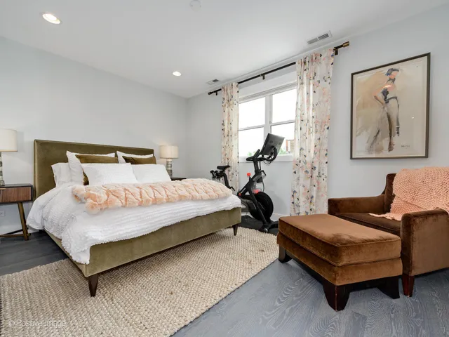 a bedroom with a bed and glass window