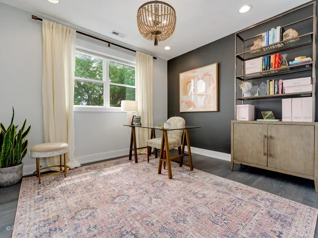 a view of a livingroom with furniture and a bookshelf