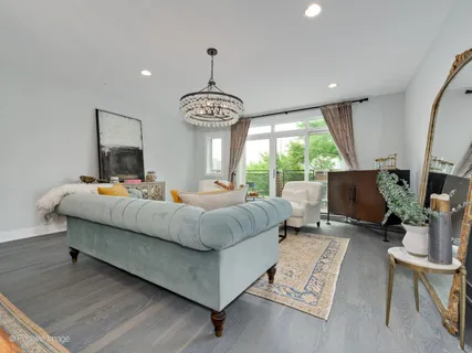 a bedroom with furniture and a large window