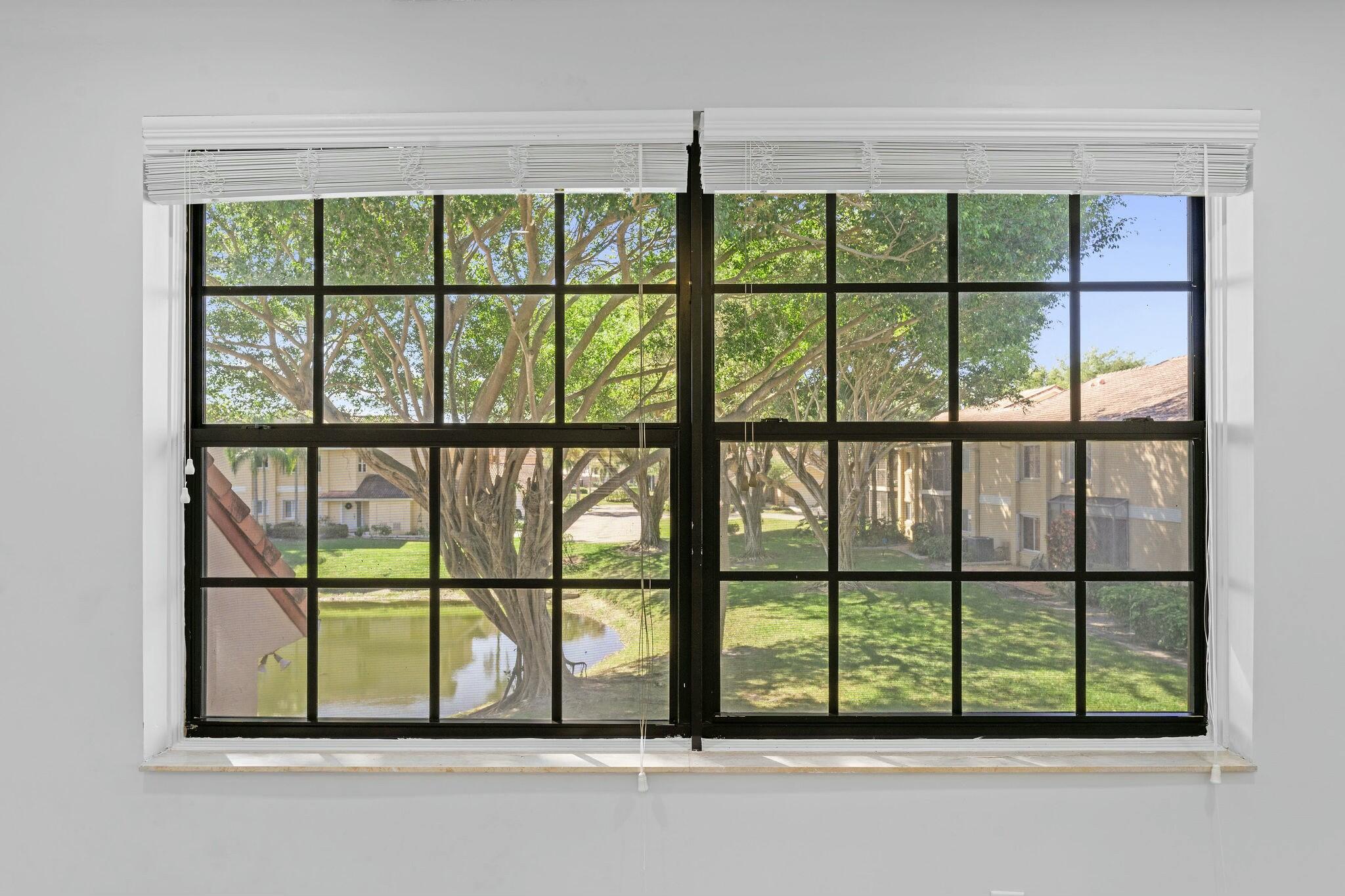 23032 Island View, Unit H Boca Raton, FL 33433 - Photo 12 of 30 a view of a garden from a window