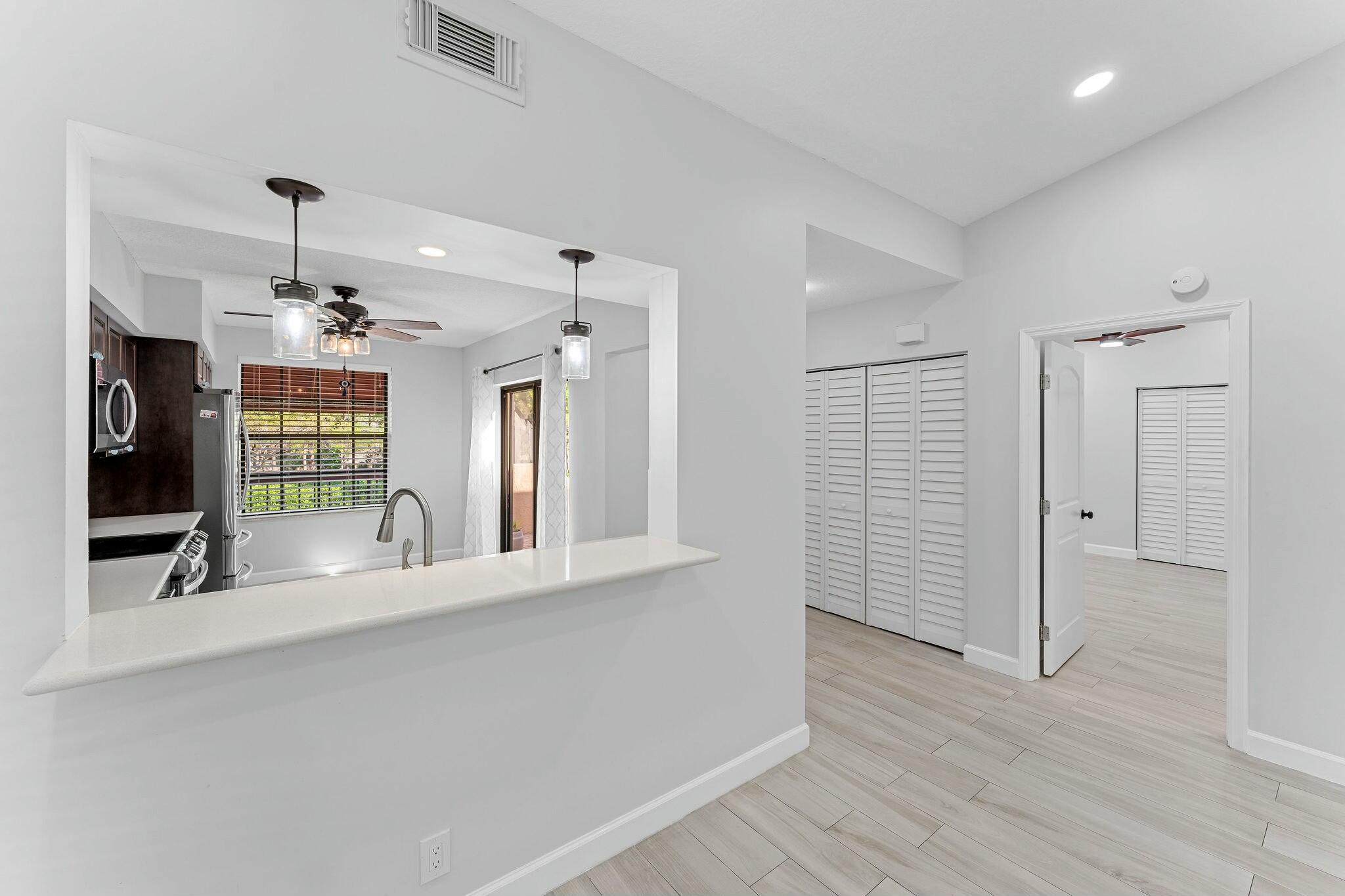 23032 Island View, Unit H Boca Raton, FL 33433 - Photo 23 of 30 wooden floor in an empty room with a window