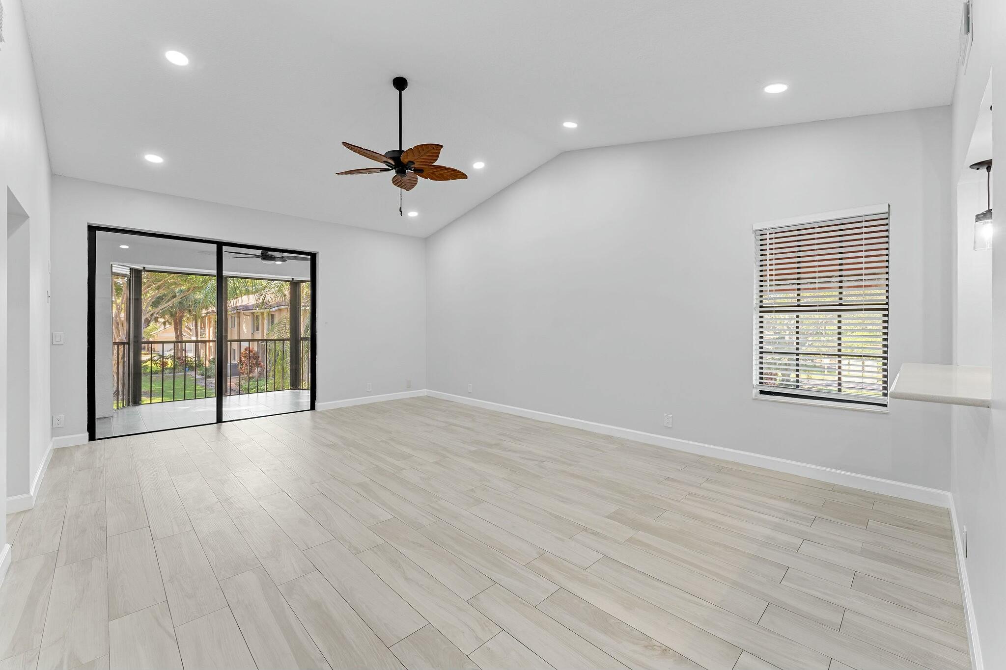 23032 Island View, Unit H Boca Raton, FL 33433 - Photo 3 of 30 an empty room with wooden floor and windows