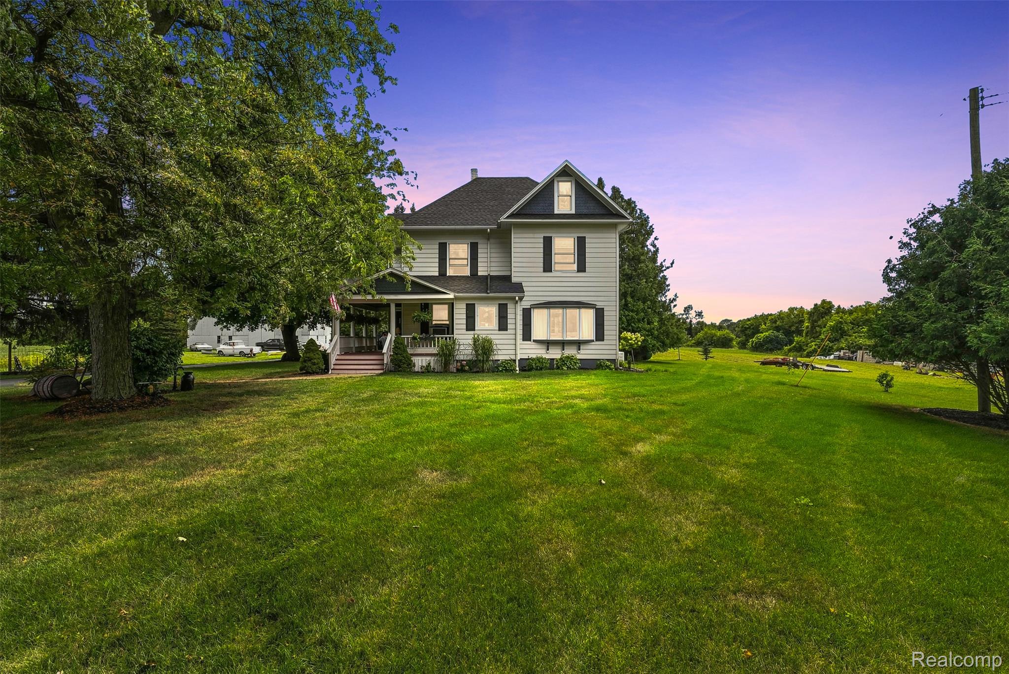 2971 Huron Line Road Cass City, MI 48726 - Photo 61 of 63 Traditional architecture with a covered front porch and expansive green lawn