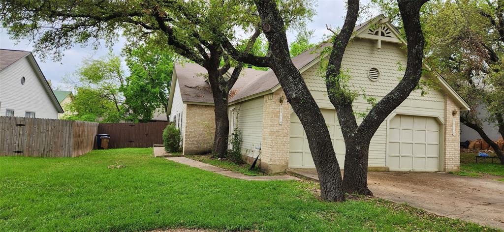 8811 Clearbrook Trail Austin, TX 78729 - Photo 1 of 38 Mature trees shade a private yard, enhancing the curb appeal of this charming residence.