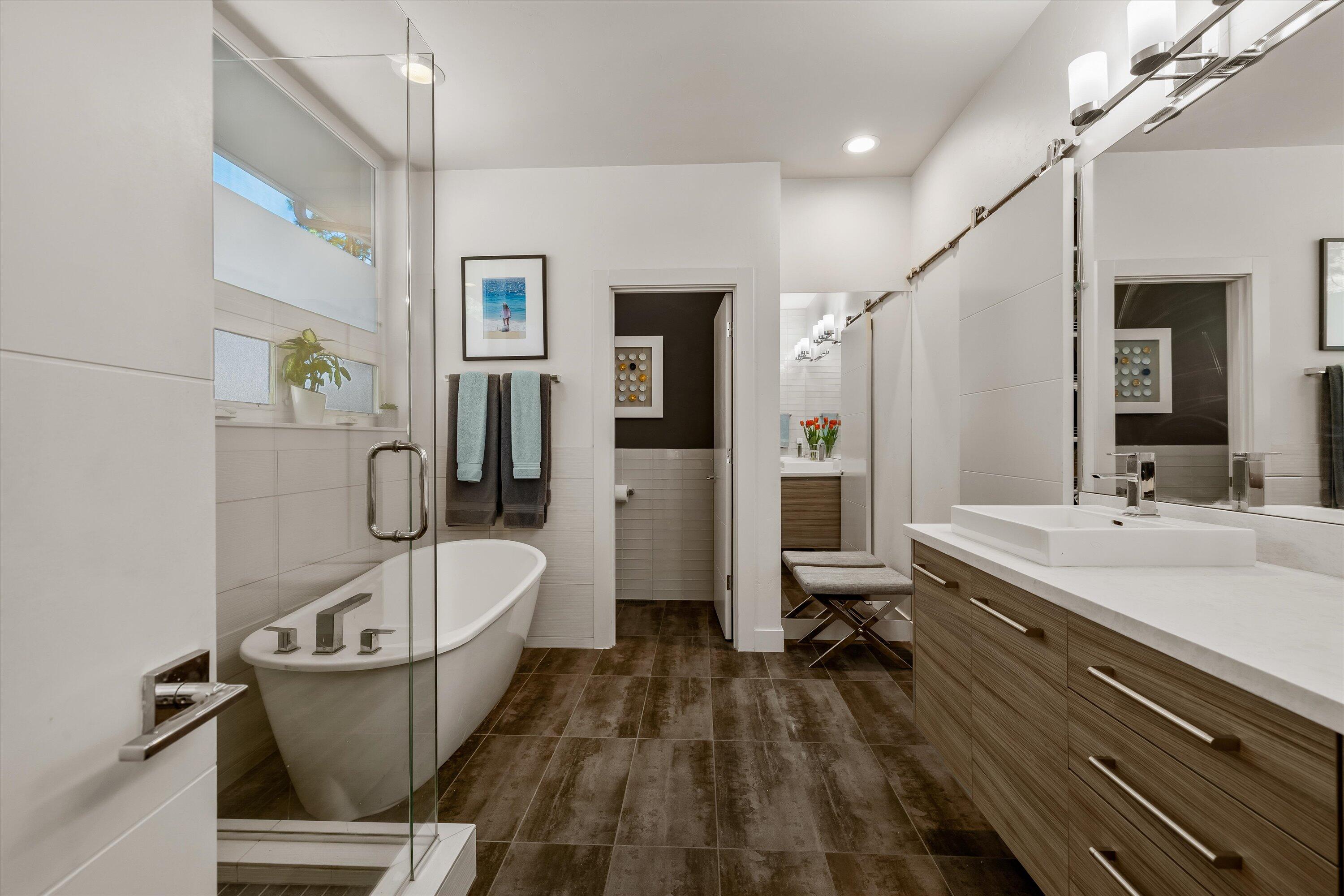 19504 Southwest Century Drive Bend, OR 97702 - Photo 23 of 58 a bathroom with a granite countertop tub sink a mirror and a shower