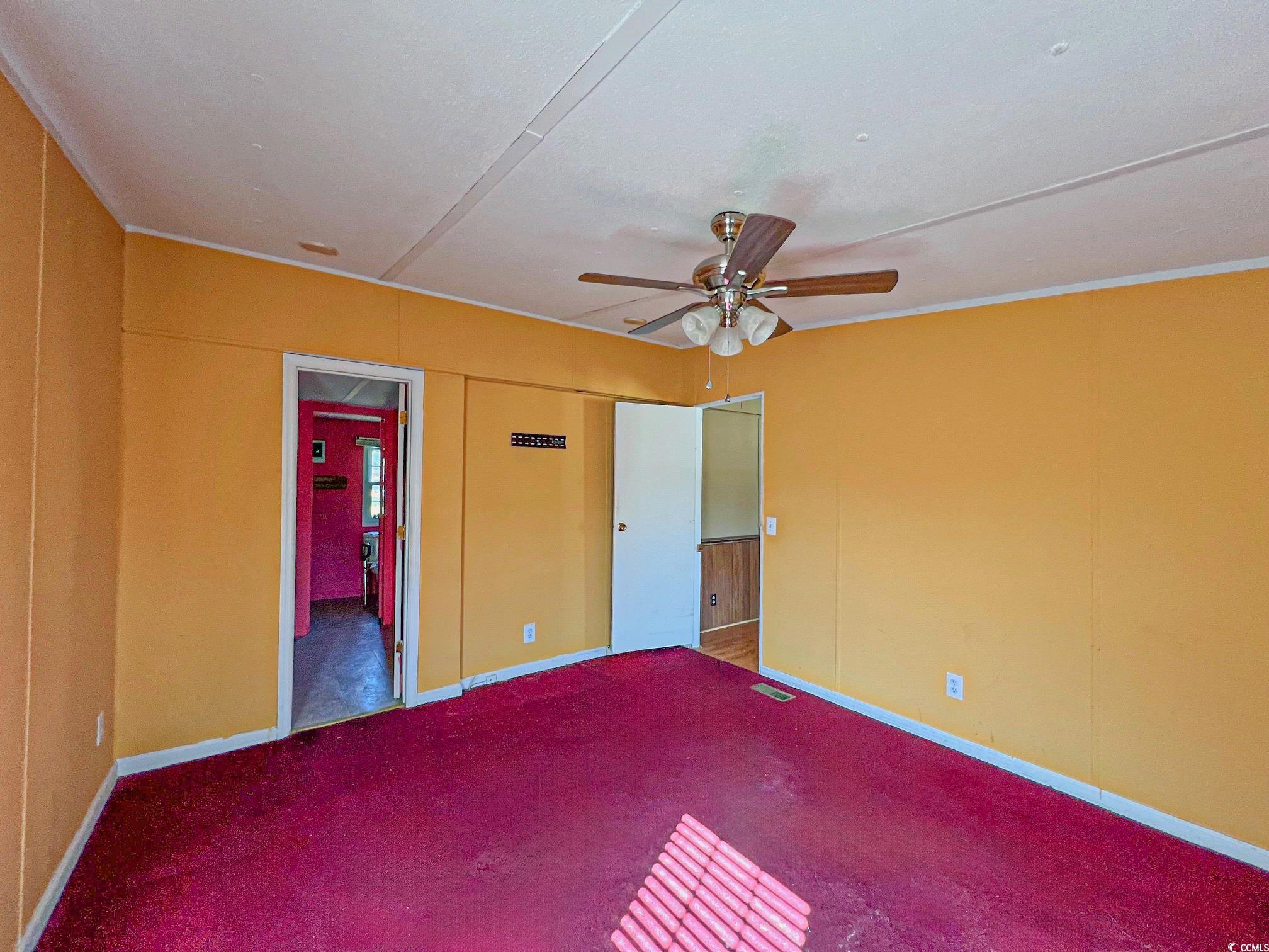 2911 Mt Olive Road Loris, SC 29569 - Photo 12 of 16 Unfurnished bedroom with ceiling fan, ornamental molding, and carpet