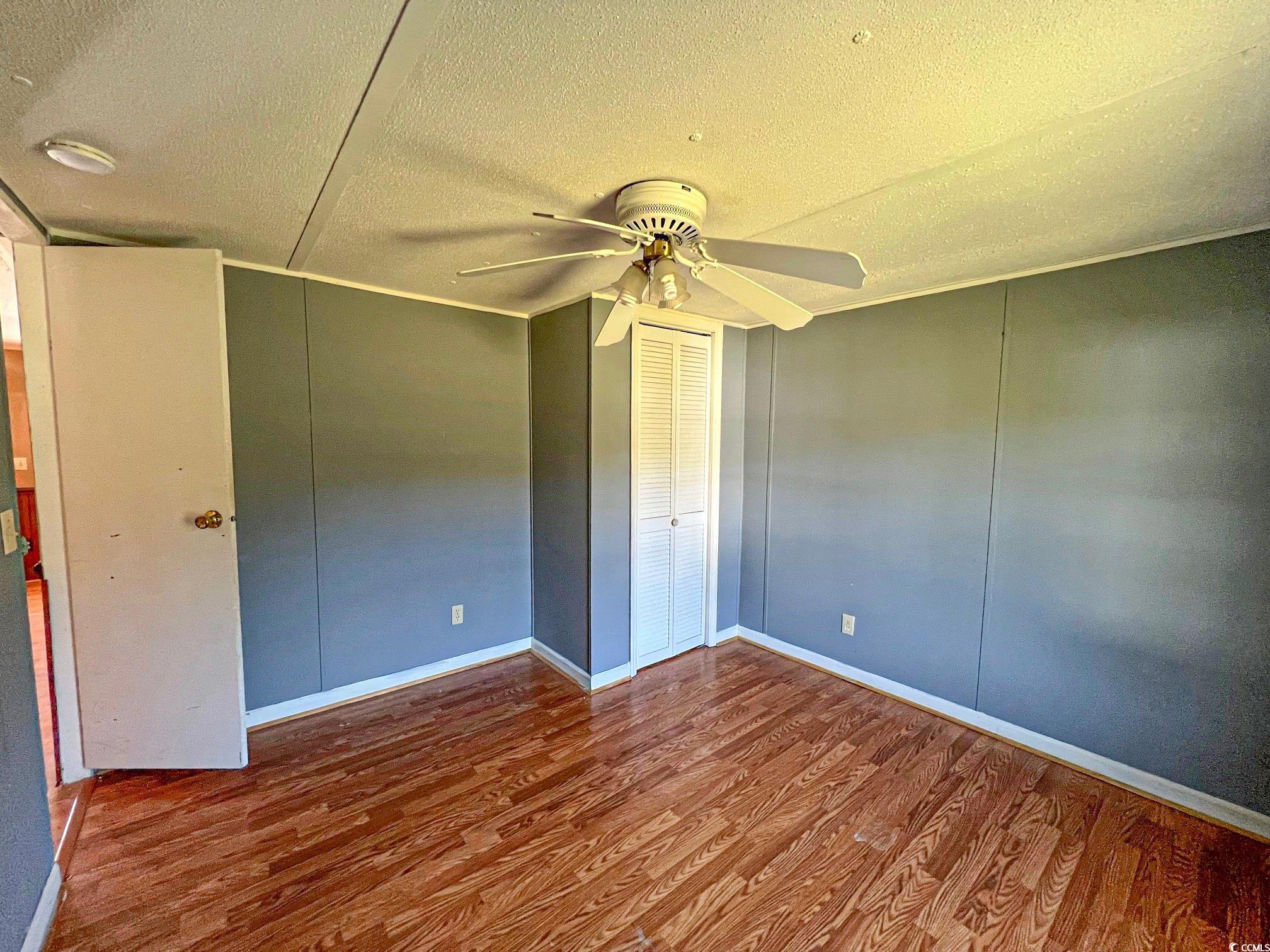 2911 Mt Olive Road Loris, SC 29569 - Photo 10 of 16 Unfurnished bedroom featuring a textured ceiling, hardwood / wood-style floors, ceiling fan, and crown molding